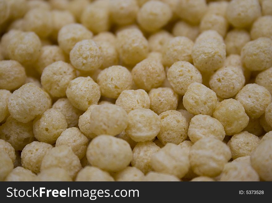 A close up shot of a bowl of puffed grain cereal.
