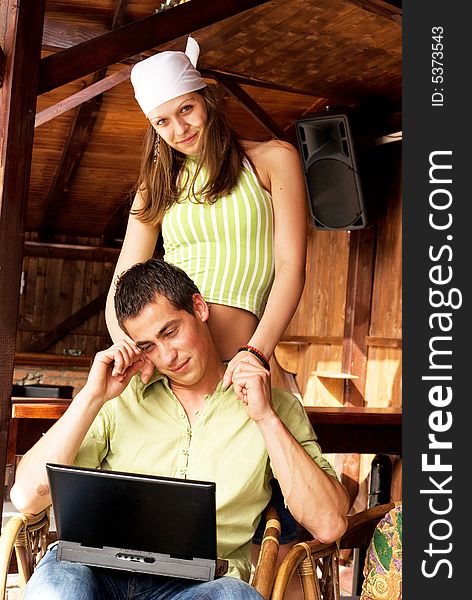 Young man and woman in restaurant with laptop. Young man and woman in restaurant with laptop