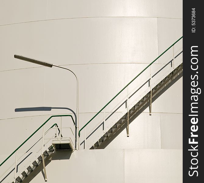 Industrial staircase with lamp at the big gas container