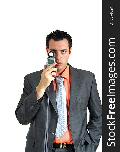 A man, wearing suit, holding a light meter in his hand, looking at the camera. A man, wearing suit, holding a light meter in his hand, looking at the camera