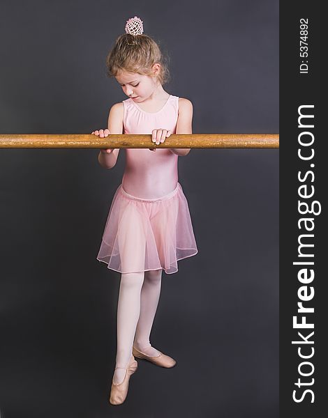 Young ballet dancer wearing an apricot tutu. Young ballet dancer wearing an apricot tutu