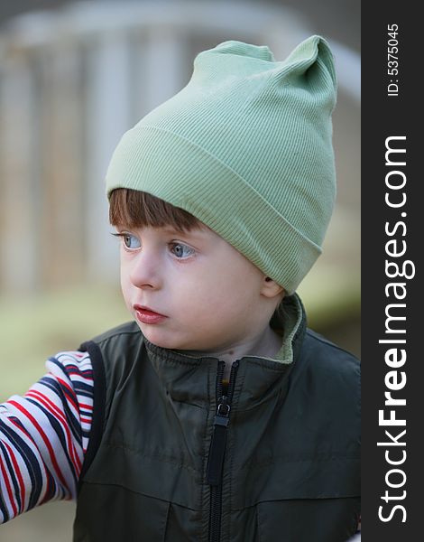 Portrait of the kid in a knitted cap