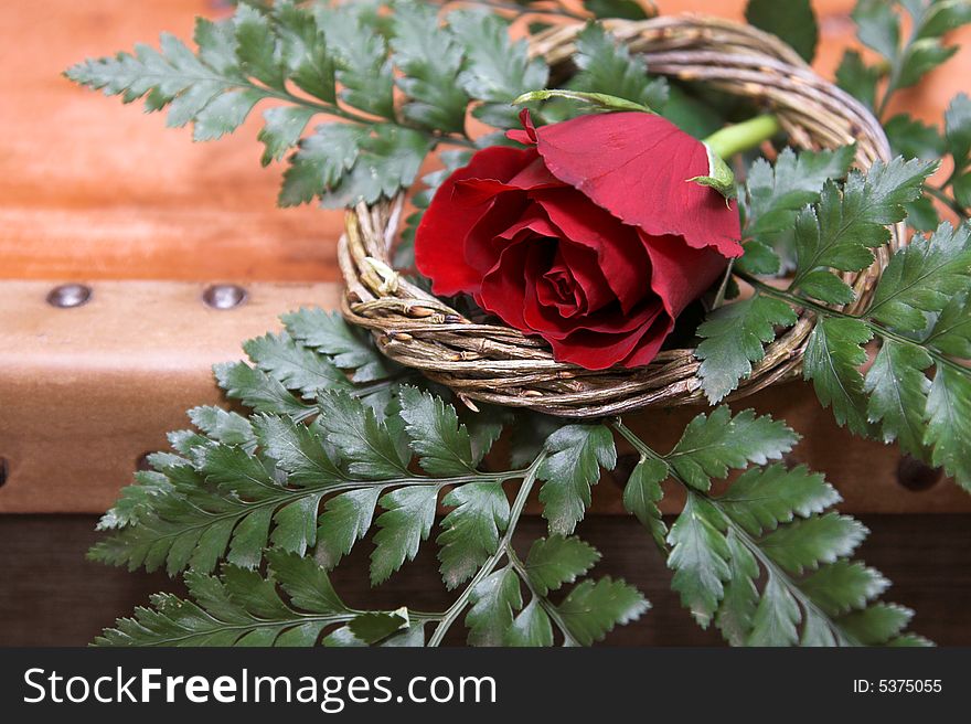 Red Rose decoration in a wreath and green leaves