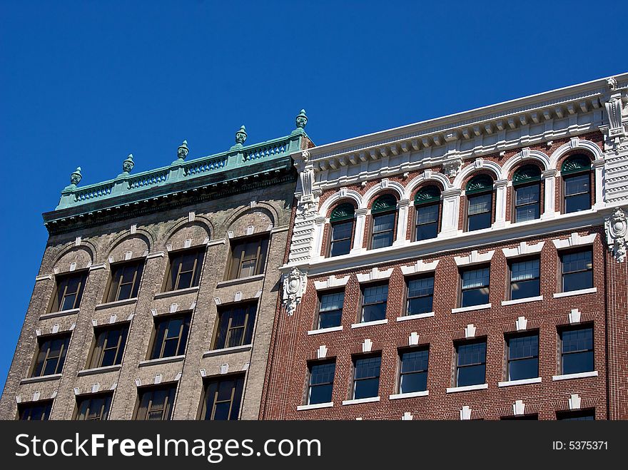 Old buildings against a deep blue sky showing detail of the roof tops