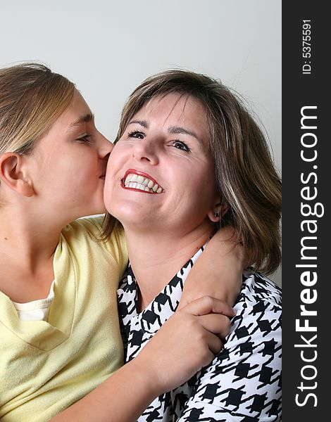 Beautiful mother and daughter on a white background