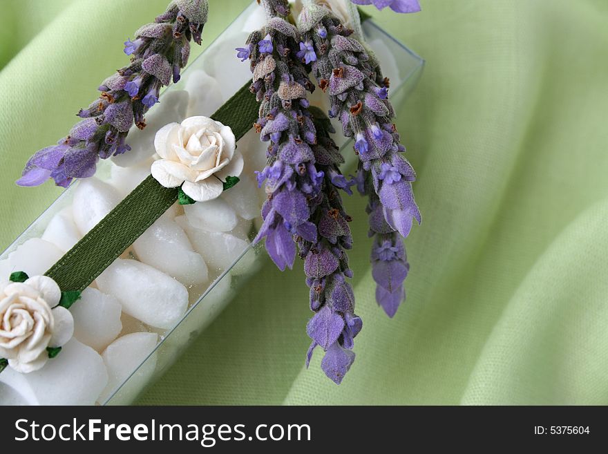 White bath crystals in a PVC box decorated with flowers