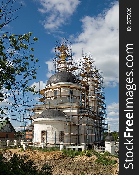 Restoration of Christian church in village in the summer