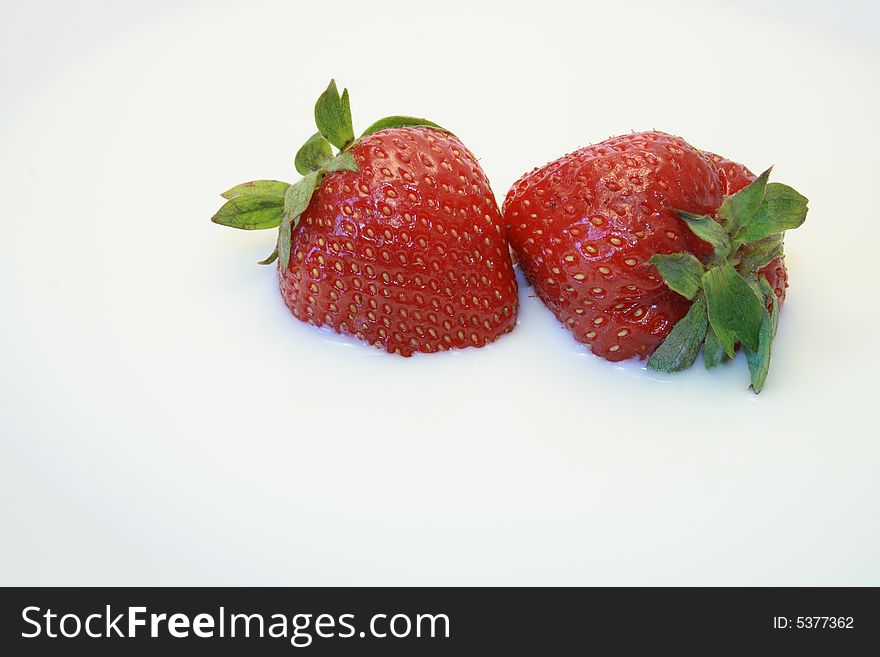 Close-up of two nice fresh strawberry lying in milk. Close-up of two nice fresh strawberry lying in milk