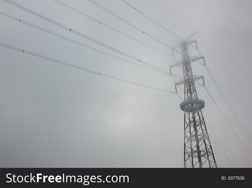 Power tower in the morning fog