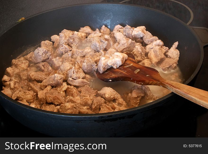 Preparation of meat with pan close-up