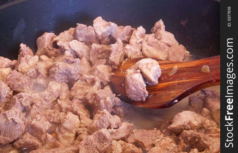 Preparation of meat at the pan close-up