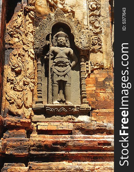 In Cambodia in the ancient city of Roulos the Hindu temple of Preah Ko orï¿½ The sacred bullï¿½ was built in the 9th century by the king Indravarman. View of a carved wall with a khmer guardian. In Cambodia in the ancient city of Roulos the Hindu temple of Preah Ko orï¿½ The sacred bullï¿½ was built in the 9th century by the king Indravarman. View of a carved wall with a khmer guardian