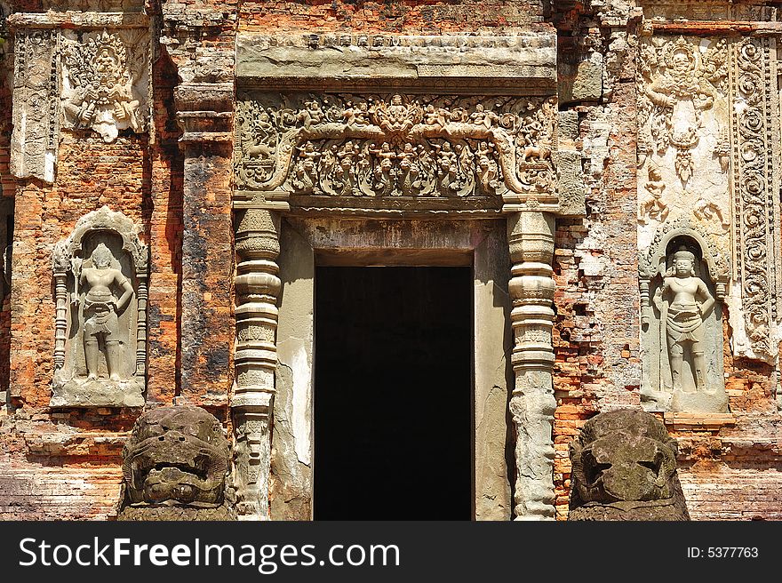 In Cambodia in the ancient city of Roulos the Hindu temple of Preah Ko orï¿½ The sacred bullï¿½ was built in the 9th century by the king Indravarman. View of a carved entrance wall. In Cambodia in the ancient city of Roulos the Hindu temple of Preah Ko orï¿½ The sacred bullï¿½ was built in the 9th century by the king Indravarman. View of a carved entrance wall