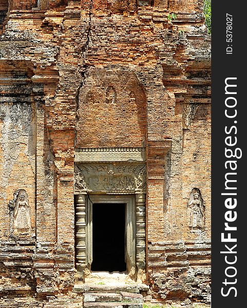 In Cambodia in the ancient city of Roulos the Hindu temple of Bakong was built in the 9th century by the king Indravarman I. View of one carved stone entrance. In Cambodia in the ancient city of Roulos the Hindu temple of Bakong was built in the 9th century by the king Indravarman I. View of one carved stone entrance