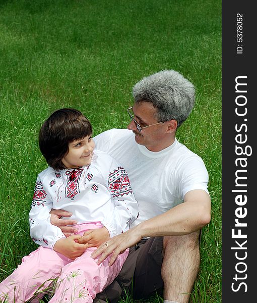 Father and daughter on green grass.happy family