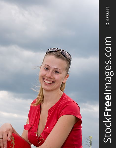 Smiling girl over cloudy sky