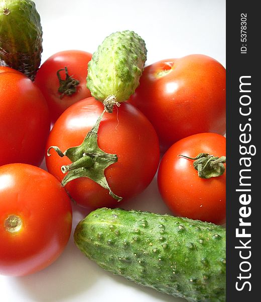 Some vegetables: tomatoes and cucumbers, red and green