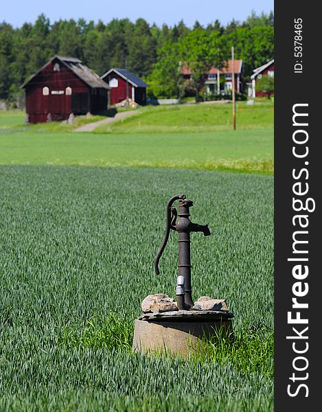 Old waterpump and idyllic countryside. Old waterpump and idyllic countryside