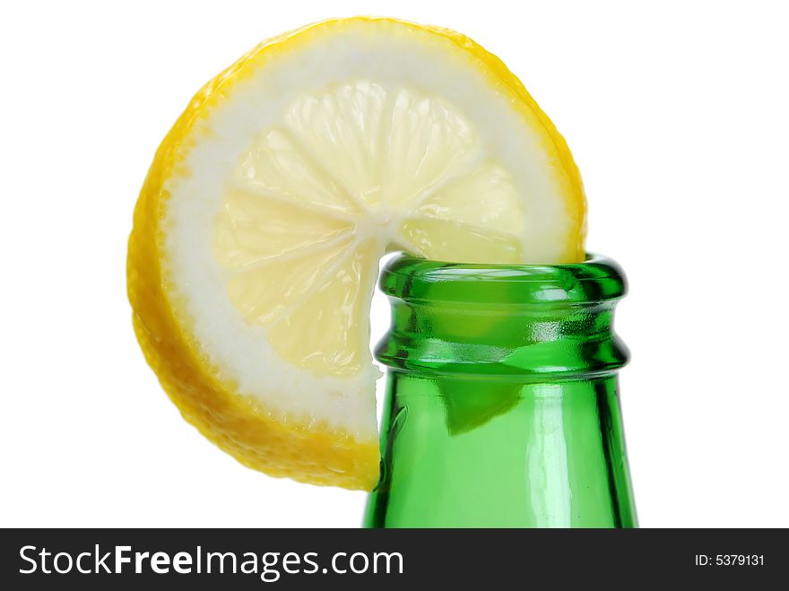 Fresh cut lemon slice on green bottle