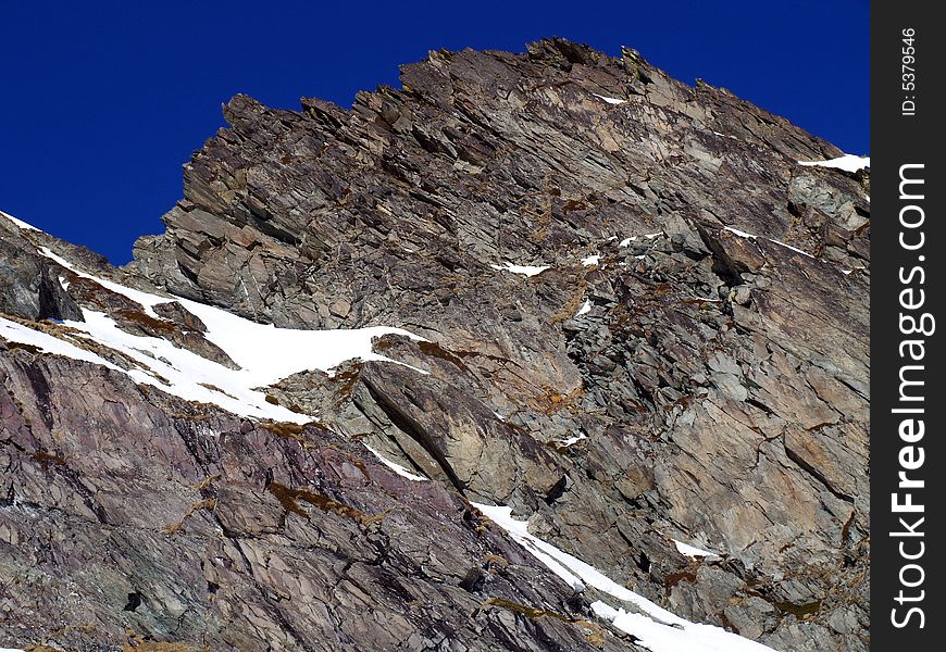 Rocks of a high mountain with blue sky