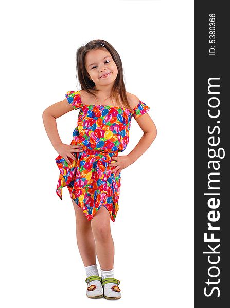 Little cute brown-haired baby girl posing in fancy-colored short dress. Little cute brown-haired baby girl posing in fancy-colored short dress