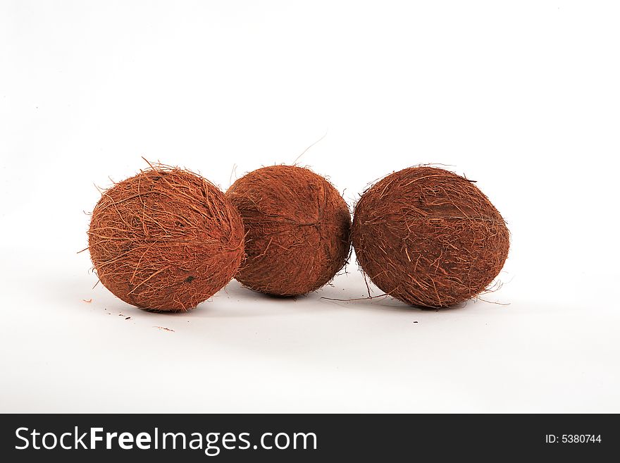 Three coconuts on a white background