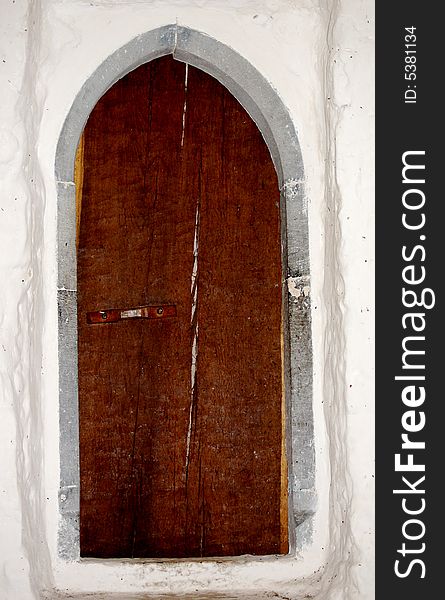 An old brown church door with a crack through the middle!. An old brown church door with a crack through the middle!