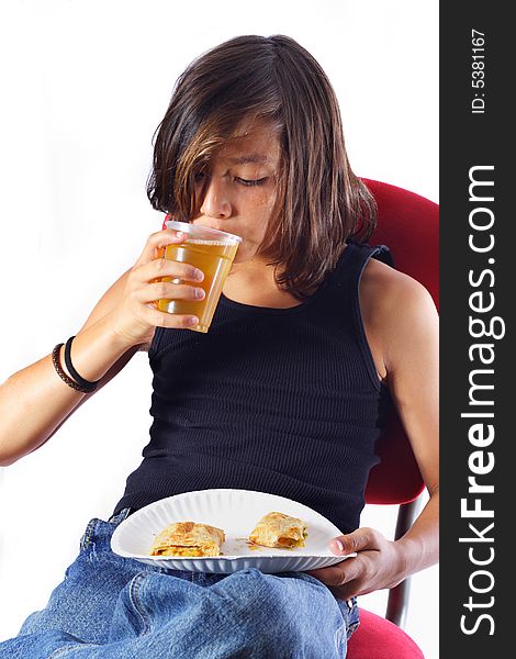 Boy taking a sip of apple juice with his lunch.