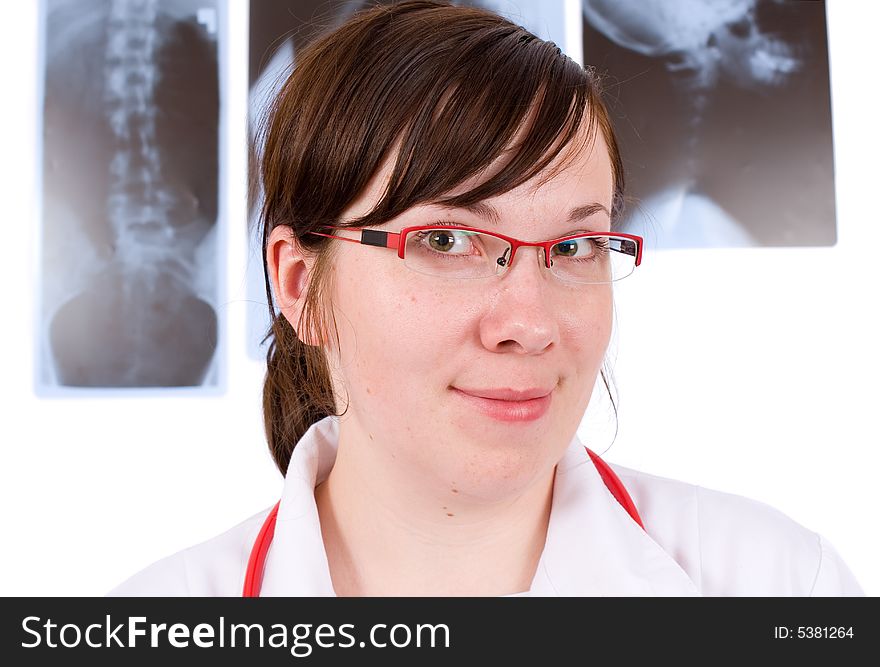 Young female doctor, three x-rays as background, isolated on white. Young female doctor, three x-rays as background, isolated on white