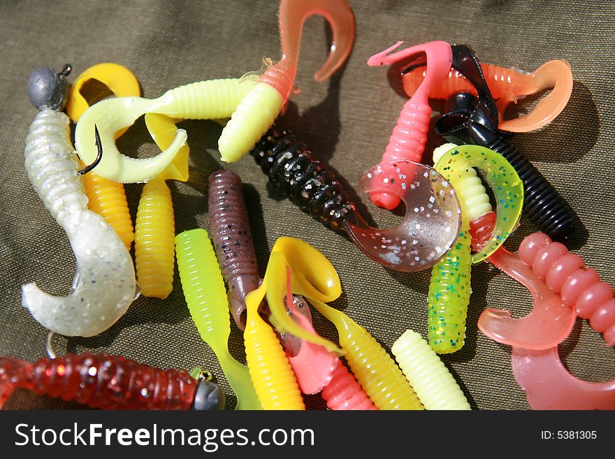 Many colour baits (soft plastic) on the linen