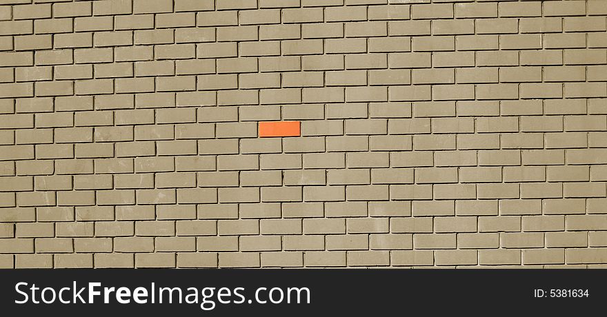 Gray Brick wall with one red brick