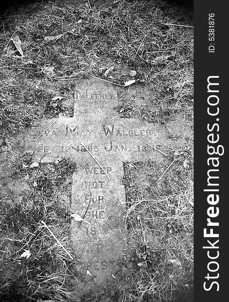 Grave stone covered in debris