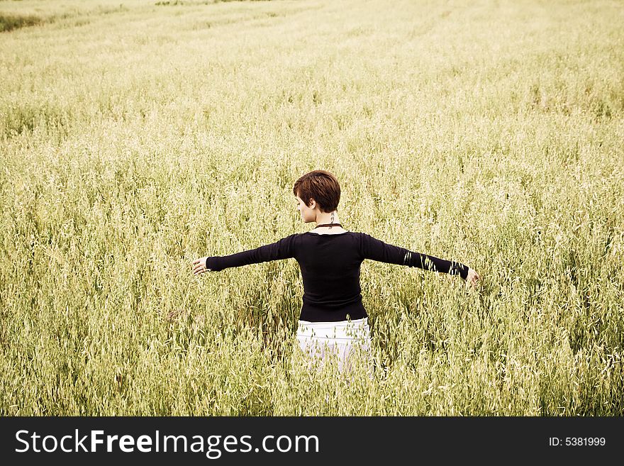 Woman feeling freedom in a field. Woman feeling freedom in a field.