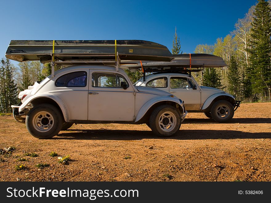 VW Bugs on mountain expidition with canoes. VW Bugs on mountain expidition with canoes