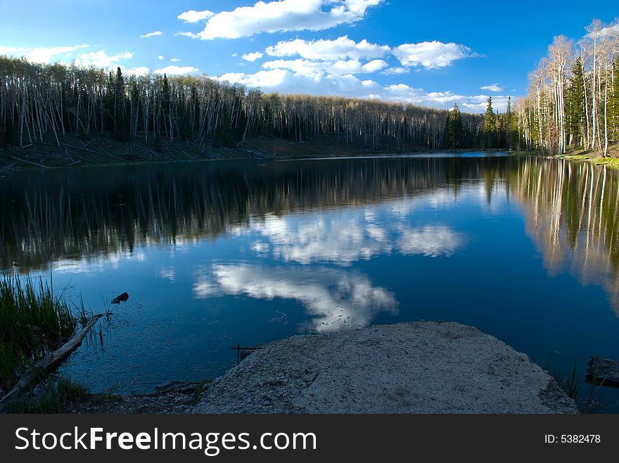 Glassy vacation lake in glorious untouched mountain range in winter. Glassy vacation lake in glorious untouched mountain range in winter