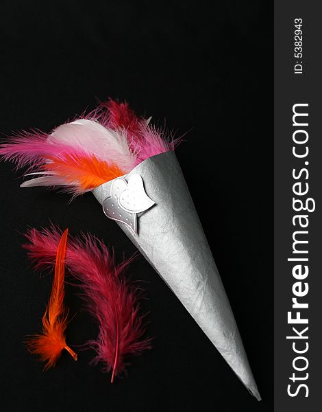 Brightly colored feather confetti in a cone