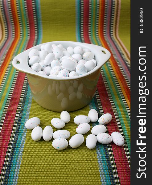 Miniature speckled easter eggs in a green bowl
