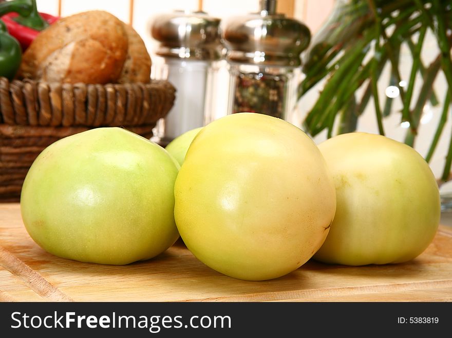 Green tomatoes in kitchen or restaurant.
