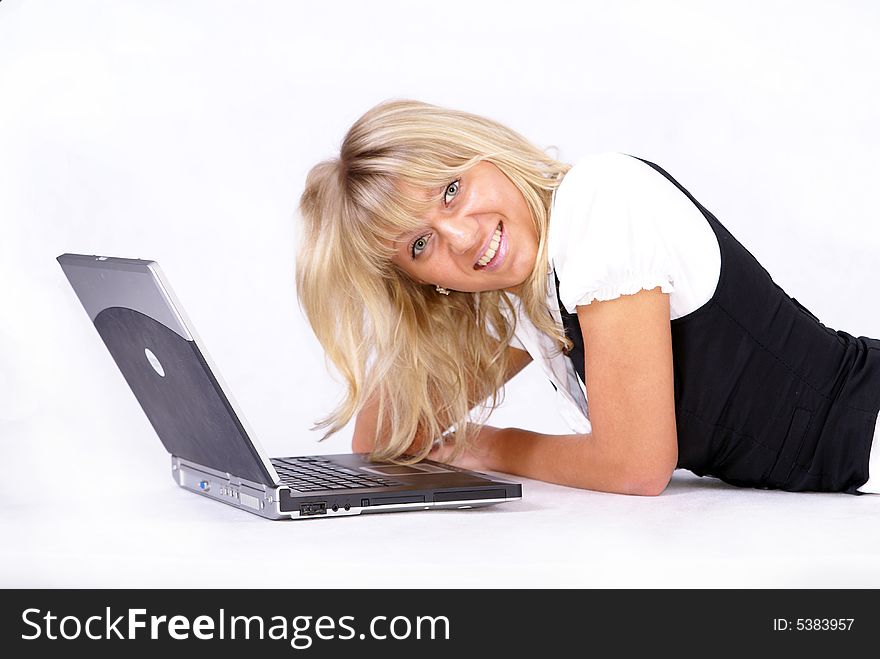 Young blond businesswoman working on floor with laptop. Young blond businesswoman working on floor with laptop.