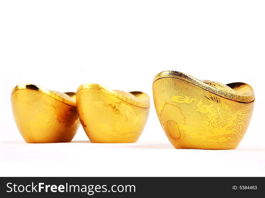 Decoration of chinese gold ingots in isolated white backgroun