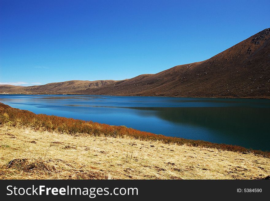 When travelling in Tibet of China, a  beautiful lake on field appears in front of us.