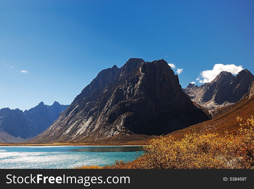 When travelling in Tibet of China, a grand mountain beside a lake appears in front of us. When travelling in Tibet of China, a grand mountain beside a lake appears in front of us.