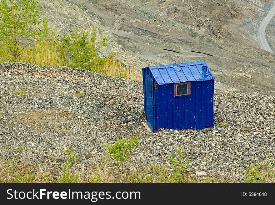 A little blue cabin on top of an asbestos mine