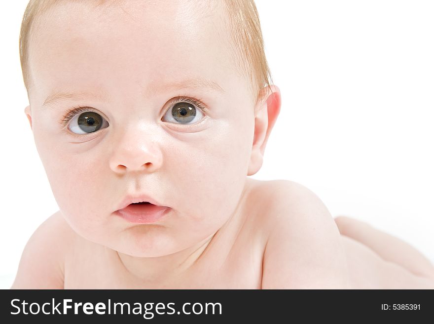 Close-up portrait of a six months old baby isolated on white