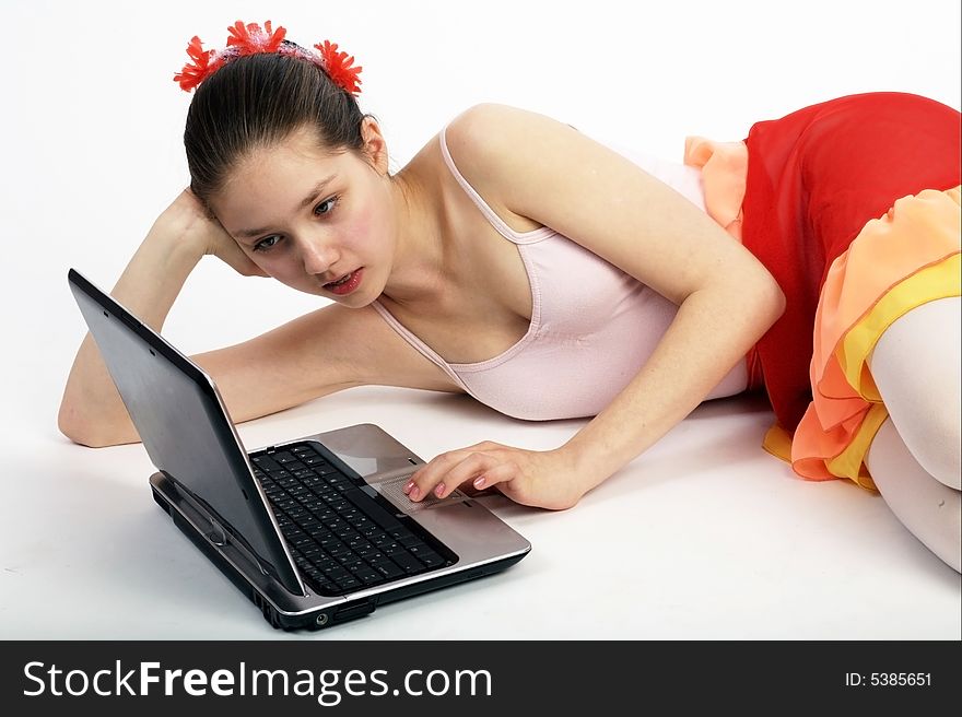 Teen girl lying on the floor with notebook computer. Teen girl lying on the floor with notebook computer