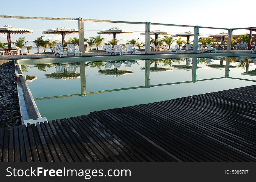 Picture of a resort's swimming pool ideal for resort or holiday context. Picture of a resort's swimming pool ideal for resort or holiday context