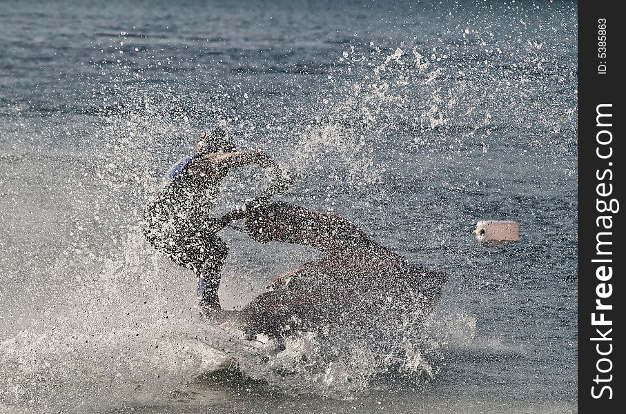 Jet ski in full speed creating splashes as it moves