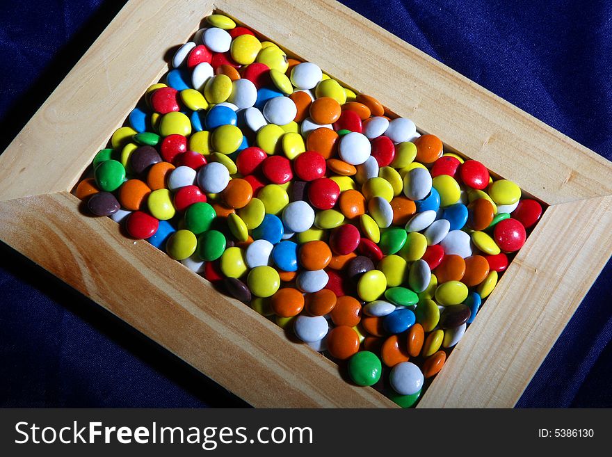 Many colored candies and a frame