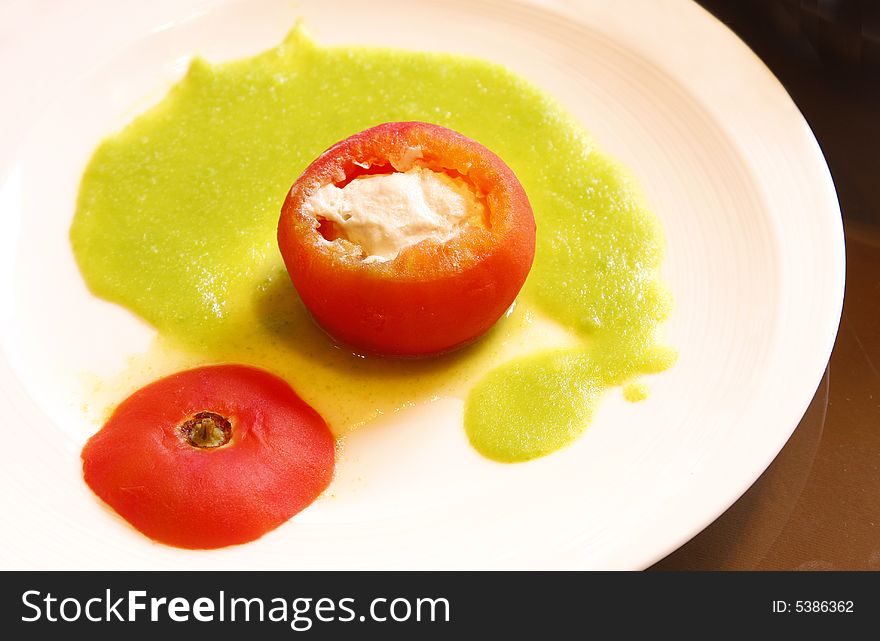 A plate of stuffed tomato with tuna fish. A plate of stuffed tomato with tuna fish