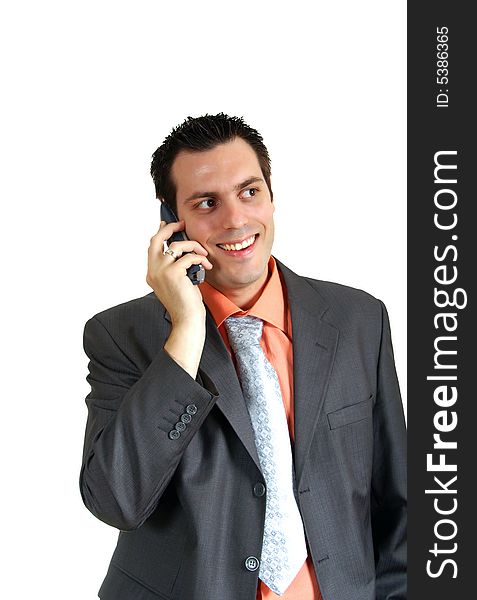 A young businessman, wearing suit, talking over the phone, looking very happy and satisfied. A young businessman, wearing suit, talking over the phone, looking very happy and satisfied